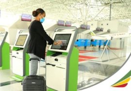 Person using self-service kiosk at airport.